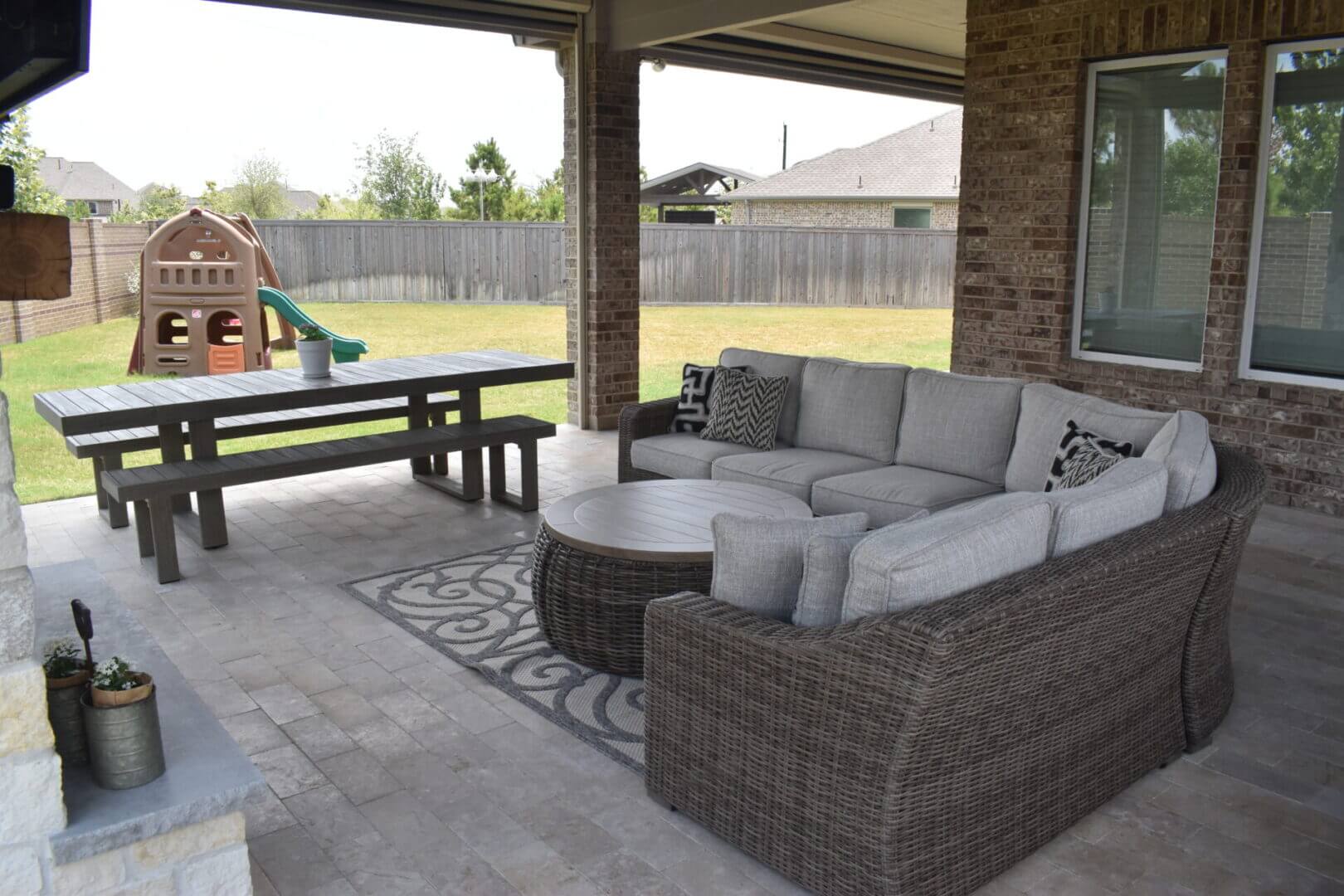 A patio with furniture and a picnic table.